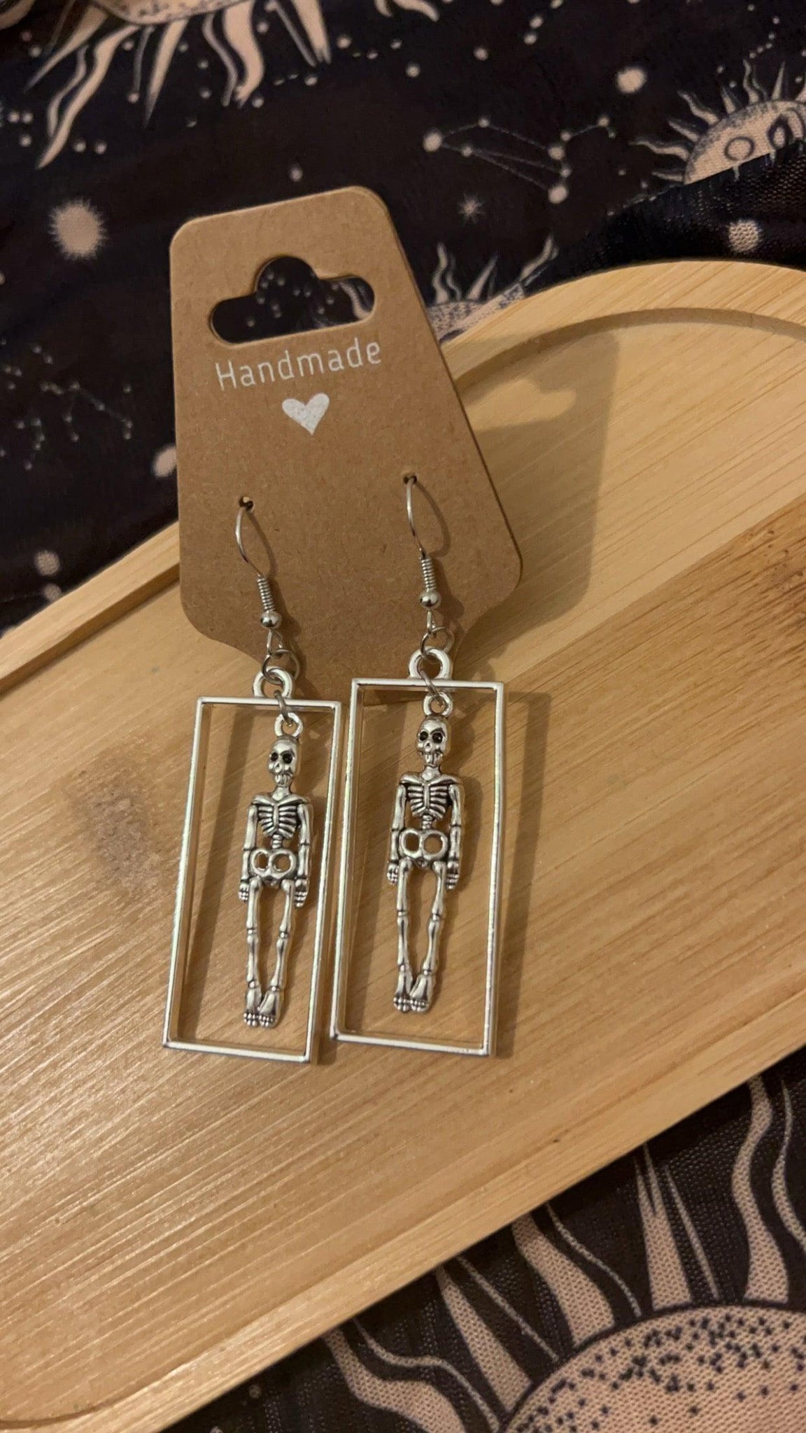 Gothic Skeleton in silver rectangle frame Earrings from a side angle 