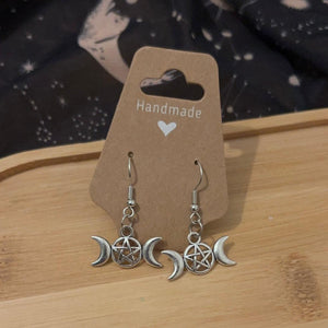 Drop style silver earrings adorned with triple moon goddess symbol with a pentacle in the middle of the full moon. 