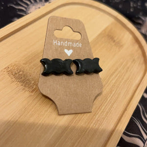 Triple moon stud earrings hand painted black on a wooden plaque 
